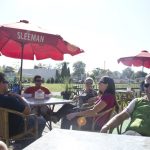 Participants of a Wine Trail Ride cycling tour enjoy the patio at Mettawas Station in Kingsville, Ontario