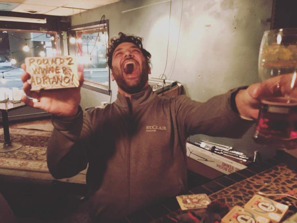 Adriano Ciotoli of WindsorEats celebrating a win at the Coaster Throwing Championships at Phog Lounge in Windsor, Ontario.