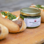 The poutine sausage from Robbie's Gourmet Sausage Co. with a jar of chimichurri from Atmosphere Fine Foods.